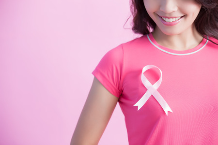 Happy Woman with pink ribbon, great for prevention breast cancer conceptの写真素材