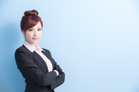 business woman is smile to you and cross arm with isolated on blue background, asianの写真素材