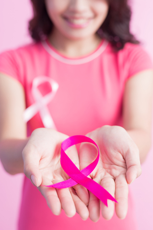 Close up of happy Woman hold pink ribbon, great for prevention breast cancer conceptの写真素材