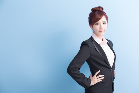 business woman is smile and arms akimbo with isolated on blue background, asianの写真素材