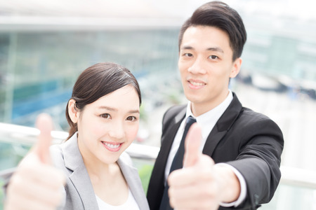 businesspeople thumb up in office in hongkongの写真素材