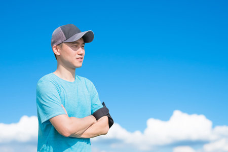 sport man look somewhere with sky, asianの写真素材