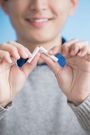 man quit smoking with blue background, asianの写真素材
