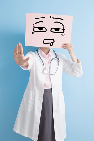 woman doctor take tired billboard and show stop ,asianの写真素材