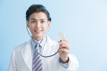 male doctor show stethoscope to you, asianの写真素材