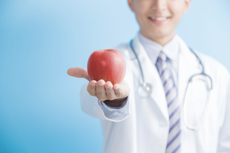 male doctor show apple to you,asianの写真素材