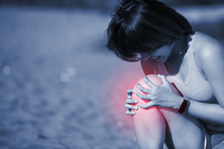 sport woman knee injury and feel pain, asian beautyの写真素材