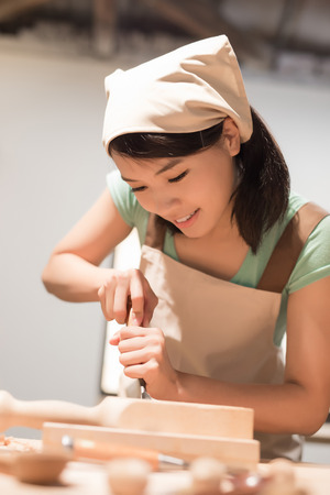 woman woodworking look and smile happily ,asianの写真素材