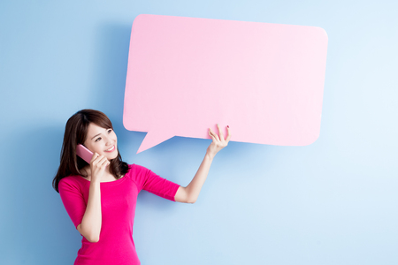 beauty woman take speech bubble billboard and talk on phoneの写真素材