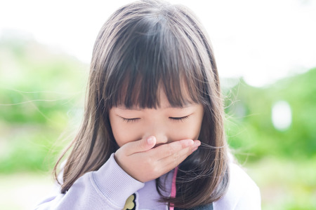 cute little girl get cold and feel vomit, asianの写真素材