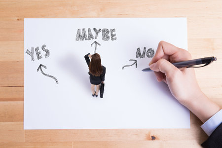 back view of business woman look white wall and think with yes or no choice stand on paperの写真素材