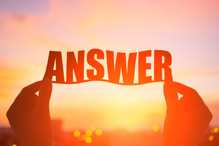 silhouette of hand take answer word with sunsetの写真素材