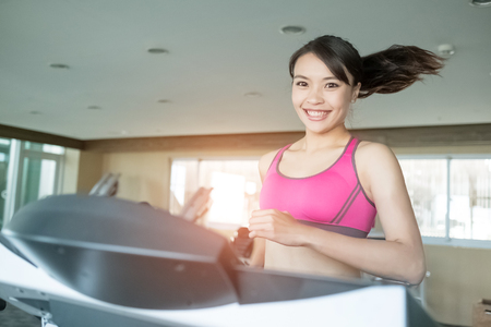 woman run on treadmill in the gymの写真素材