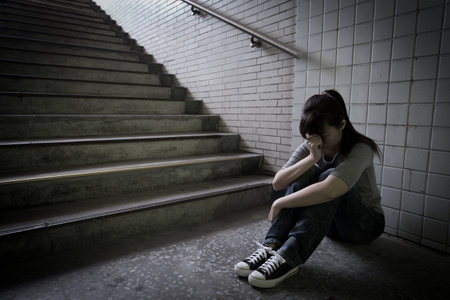 depressed woman feel upset and sit in undergroundの写真素材