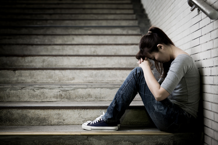 depressed woman feel upset and sit in undergroundの写真素材