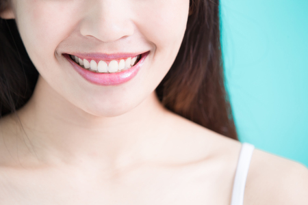 beauty woman with tooth whiten concept on green backgroundの写真素材