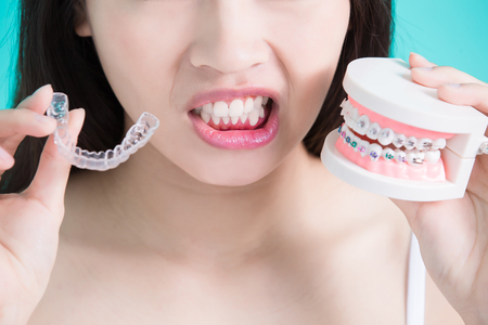 woman choicce different brace on green backgroundの写真素材