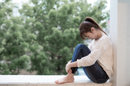 woman feel depression and next to the balconyの写真素材