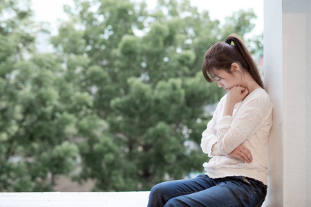 woman feel depression and next to the balconyの写真素材