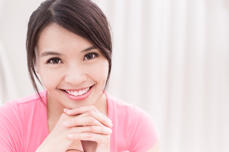 woman smile happily and look you in the roomの写真素材
