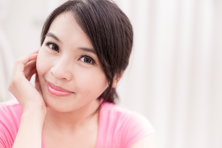 woman smile happily and look you in the roomの写真素材