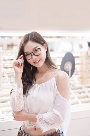 beauty woman wear eyeglasses in the storeの写真素材