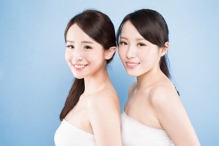 two beauty woman with healthy skin care on the blue backgroundの写真素材
