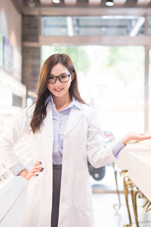 beauty woman optometrist smile happily and show somethingの写真素材