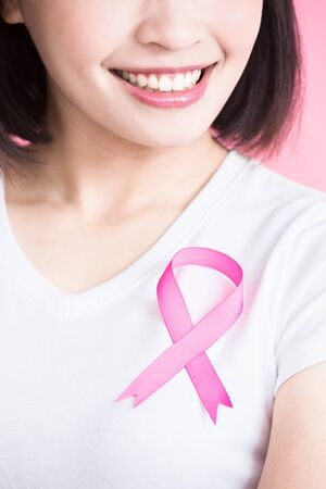 woman with chest health concept on the pink backgroundの写真素材