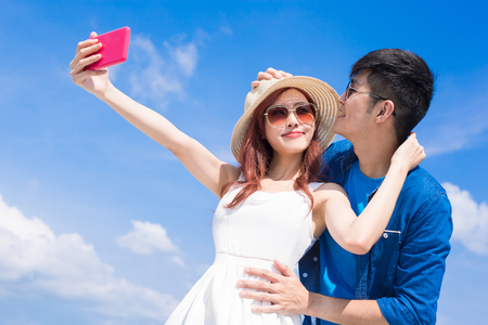 couple selfie happily with the blue skyの写真素材