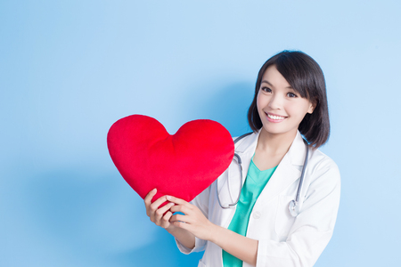 beauty woman doctor take heart on the blue backgroundの写真素材
