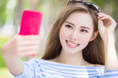 beauty woman selfie happily in the parkの写真素材