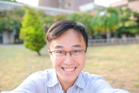 man selfie and smile happily in the parkの写真素材