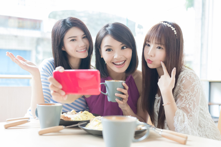 woman friends smile and selfie in restaurantの写真素材
