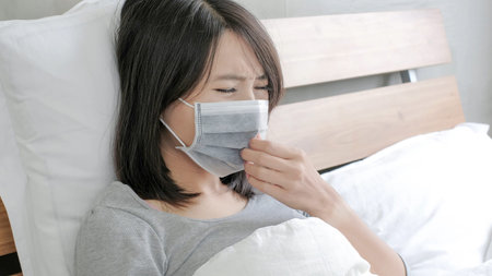 woman get sick and fever lying on the bed