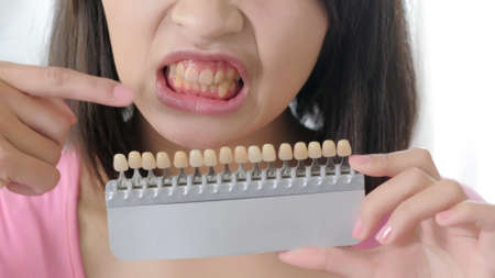 woman take tooth color palette with whiten conceptの写真素材