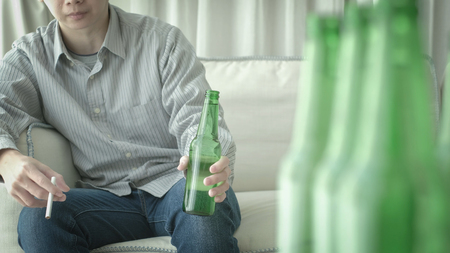 man feel depression and alcoholism in the homeの写真素材