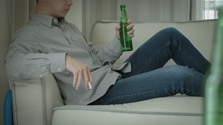 man feel depression and alcoholism in the homeの写真素材