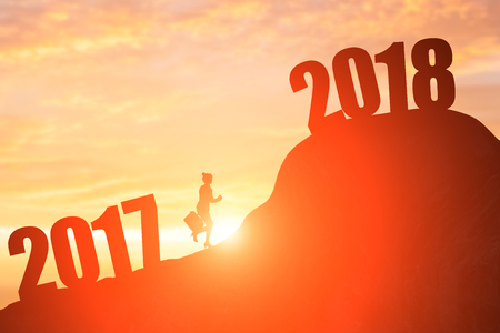 silhouette of businesswoman run on the moutain with 2018 yearの写真素材