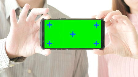 people take cell phone with green screen in the home
