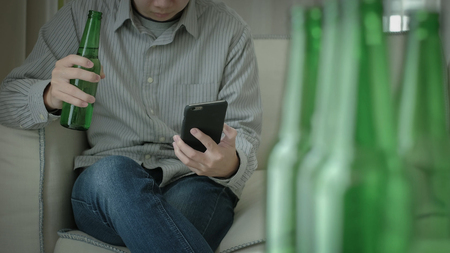 man feel depression and alcoholism in the homeの写真素材