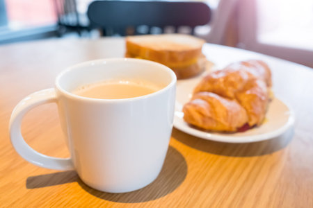close up of coffee and bread on the table