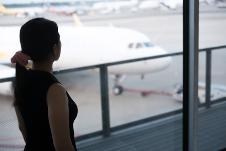 A woman look some where in the airportの写真素材