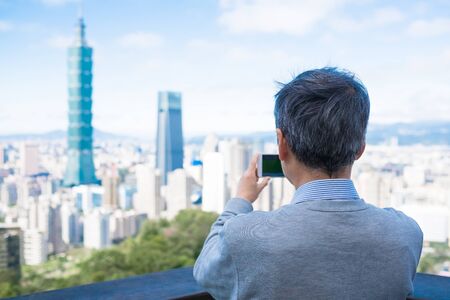 old man take picture on the moutainの写真素材