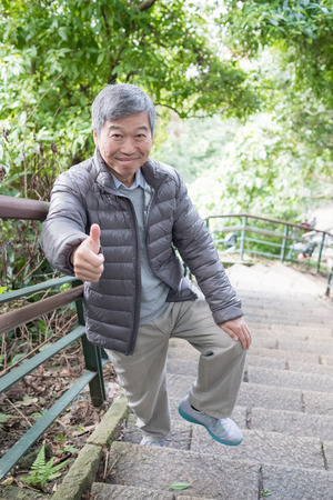 old man with health knee and climb moutainの写真素材