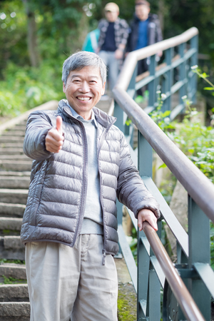 old man with health knee and climb moutainの写真素材
