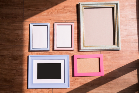 blank photo frame with copy space on floor at roomの写真素材