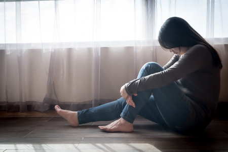 woman sit and feel depression in the roomの写真素材