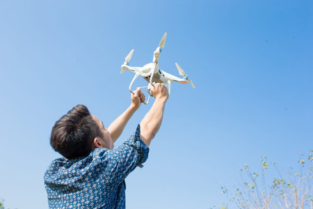 man take drone with blue sky in the park