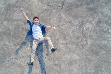 aerial shot of man feel excited and lying on the floorの写真素材